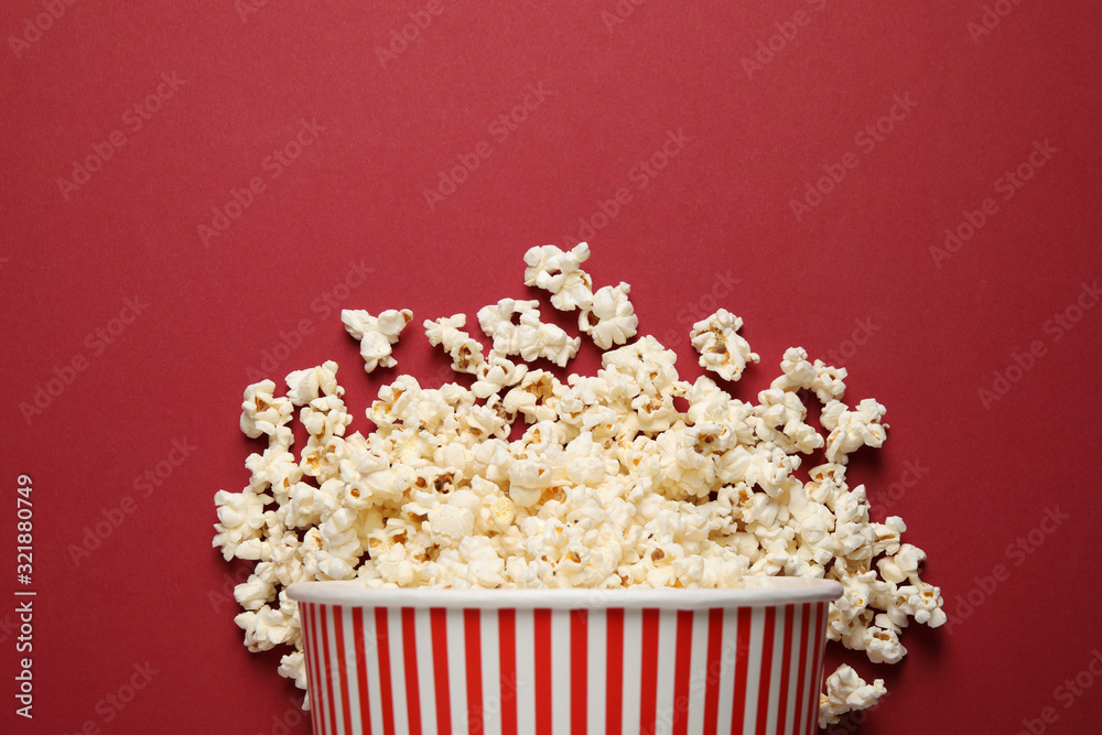 Delicious popcorn on red background, top view