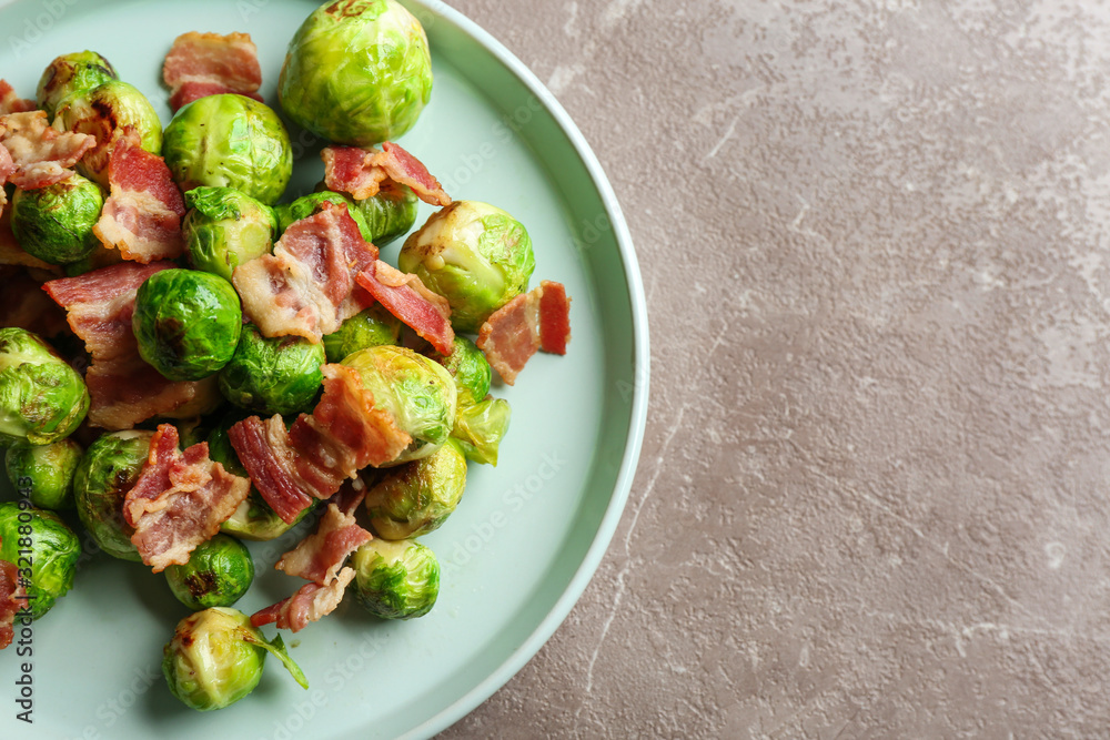 Delicious Brussels sprouts with bacon on marble table, above view. Space for text Delicious Brussels sprouts with bacon on marble table, above view. Space for text