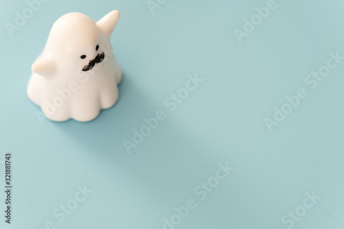 small white color plastic ghost figure in blue background view © dongli
