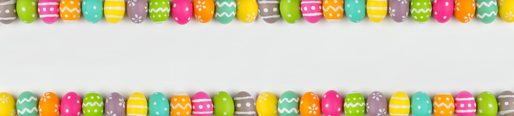 Easter banner with colorful Easter Egg double border over a white background. Above view with copy space.
