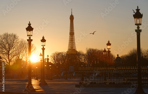 Silhouettes of the Eiffel Tower, street lamps of Concorde square at sunset Paris. © kovalenkovpetr