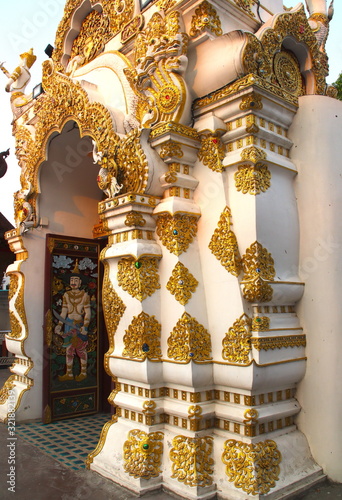 Temple in Chiangmai Thailand Beautifully decorated with wonderful colours statues of Buddha, Payanak, and Monks on walking street in the old city photo