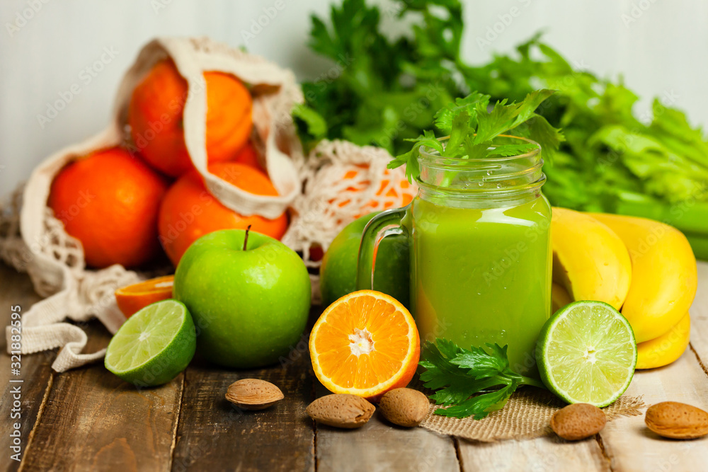Healthy eating, food and vegetarian diet concept - jar of fresh juice or smoothie with apple, celery, orange almond. Antioxidant detox beverage. Clean organic ingerdients. Close up, wooden background Healthy eating, food and vegetarian diet concept - jar of fresh juice or smoothie with apple, celery, orange almond. Antioxidant detox beverage. Clean organic ingerdients. Close up, wooden background