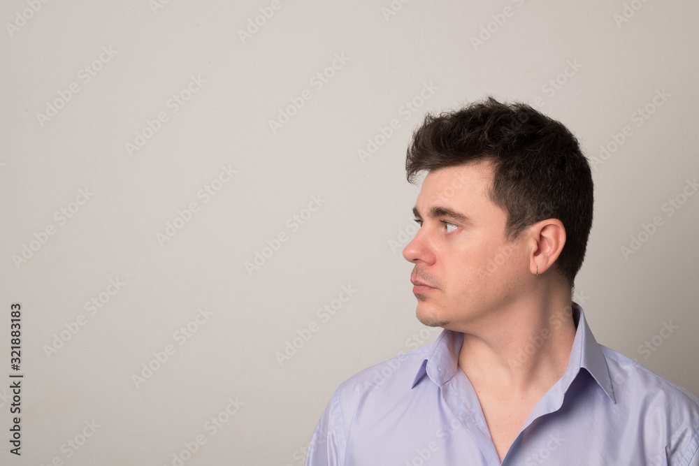 Attractive young man. Positive man with an earring in his ear. Attractive young man. Positive man with an earring in his ear.