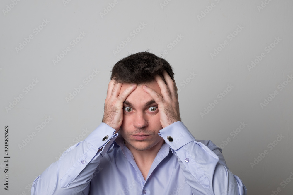 Portrait of a young man. Business man holds his head. Portrait of a young man. Business man holds his head.