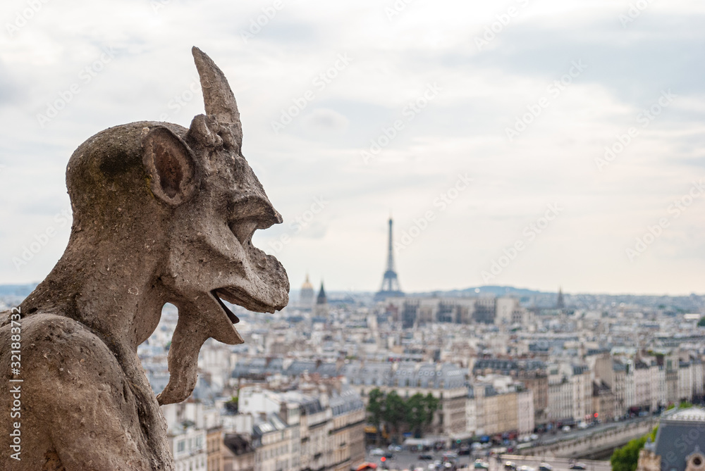 Detail of a gargoyle on the Notre Dame cathedral in Paris, France.