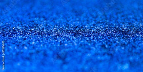Blur blue sparkle background. Defocused glitter texture