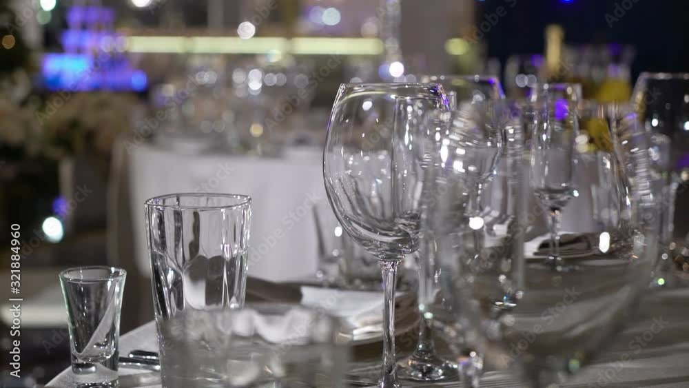 Glasses, plates and napkins in the restaurant. A covered table for a party.party, event, celebration, wedding, anniversary, birthday Glasses, plates and napkins in the restaurant. A covered table for a party.party, event, celebration, wedding, anniversary, birthday