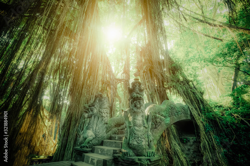 Surreal sunrise colors of fantasy Monkey Forest with Barong Lion bridge and Hindu Temple. Bali, Indonesia. Concept landscape for mysterious background photo