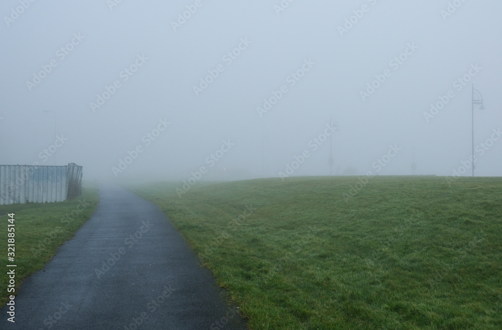 Path through a grassy park on a very foggy day, taken in Salthill near Galway
