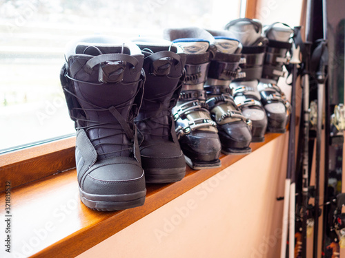 Ski and snowboard boots rental, skis and poles. Skiing equipment rented. Close up.