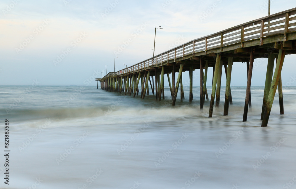 Fishing Pier after sunset at Virginia Beach, Virginia, USA. Long Exposure Applied to slow the water motion.