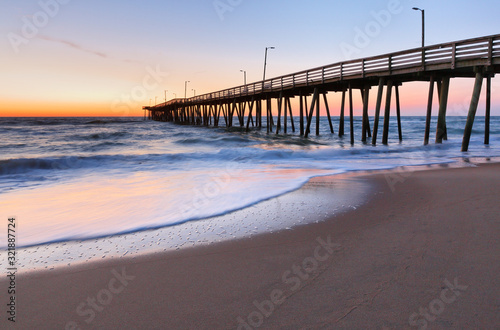 Fishing Pier at Sunrise at Virginia Beach  Virginia  USA. Virginia Beach  a coastal city in southeastern Virginia  lies where the Chesapeake Bay meets the Atlantic Ocean.