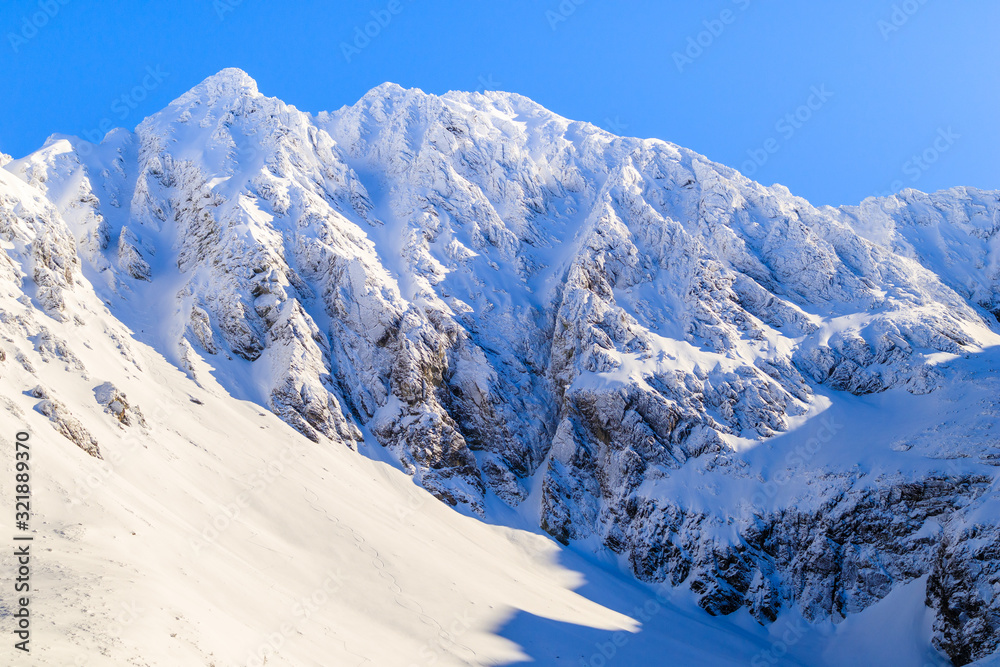 View of beautiful peaks covered by fresh snow near Czarny Staw lake in Gasienicowa valley, Tatra Mountains, Poland