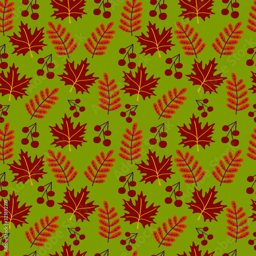 Seamless pattern with autumn leaves and branches on green background. 