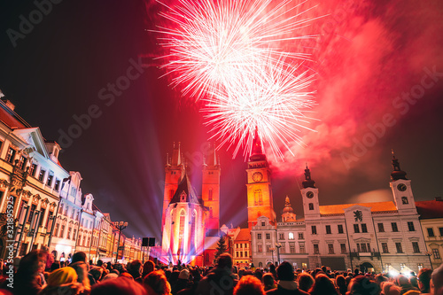 Red fireworks in historic city center of Hradec Kralove, Czech Republic. Crowd of people in foreground.