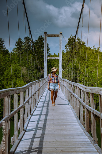 MuKo Chumphon National park,Thailand , woman walking on wooden deck in the park with trees and mangrove in Chumphon Thailand photo