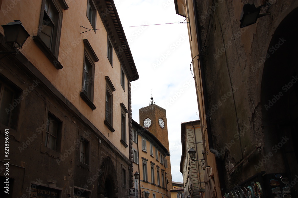 street scene with clock tower in old town of orvieto