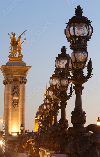 The bonze lamps on famous Alexander III Bridge in evening, Paris.