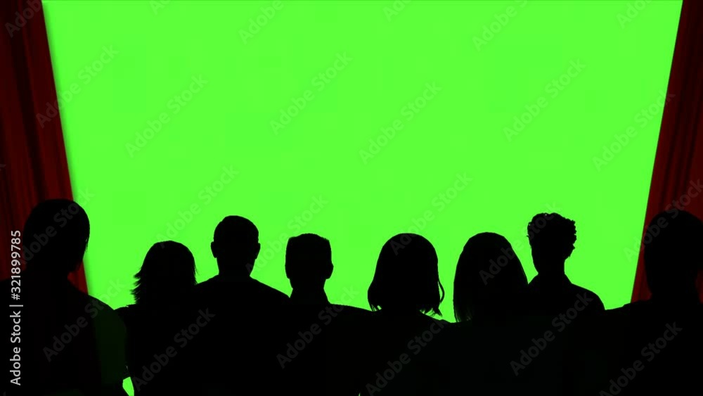 Red curtains open to green screen in front of crowd