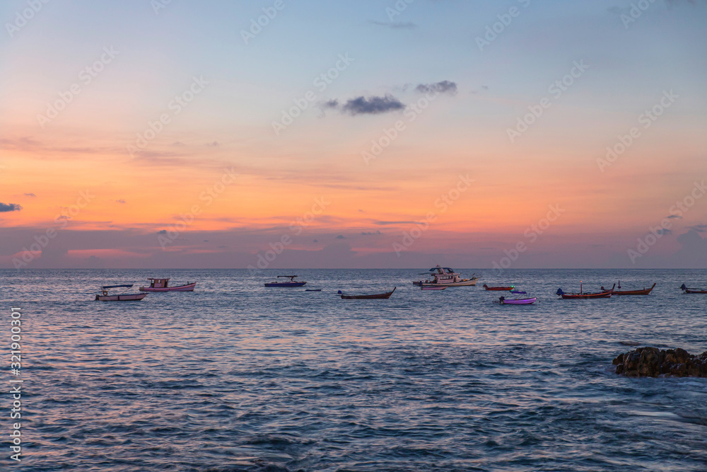 Fishing boats at sea and sunset. Phuket, Patong, Thailand.