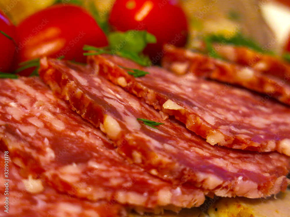 meat cuts for the festive table: salami sausage, boiled tongue, tomatoes and greens meat cuts for the festive table: salami sausage, boiled tongue, tomatoes and greens