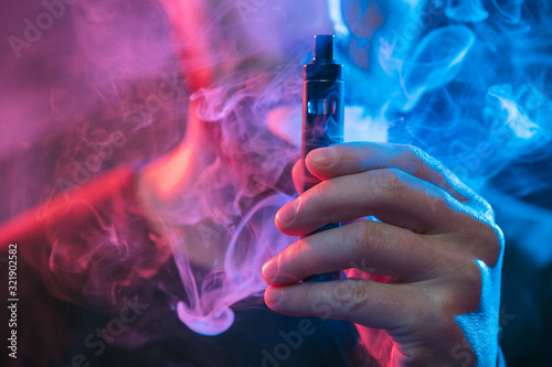 Vaping e-liquid from an electronic cigarette photo