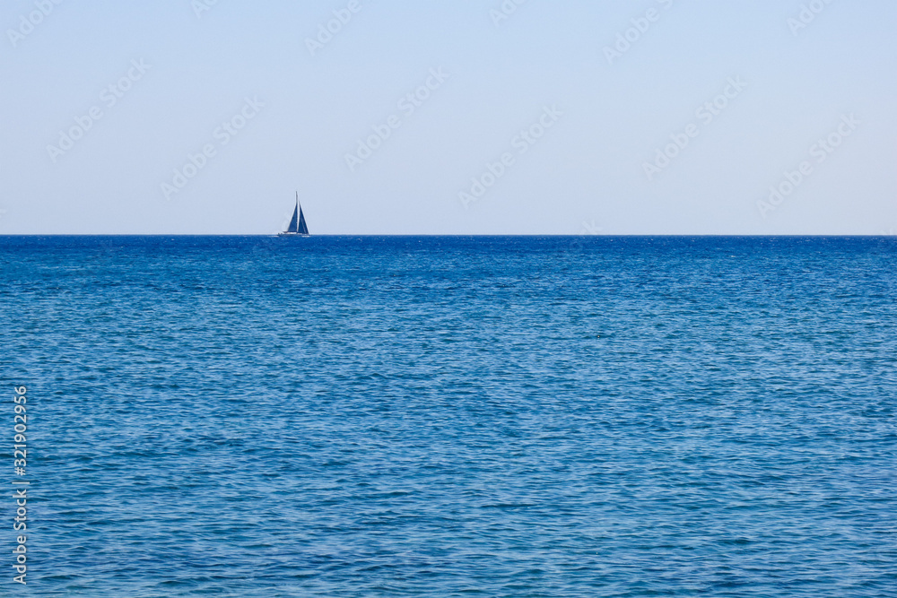 A lonely boat on the sea horizon