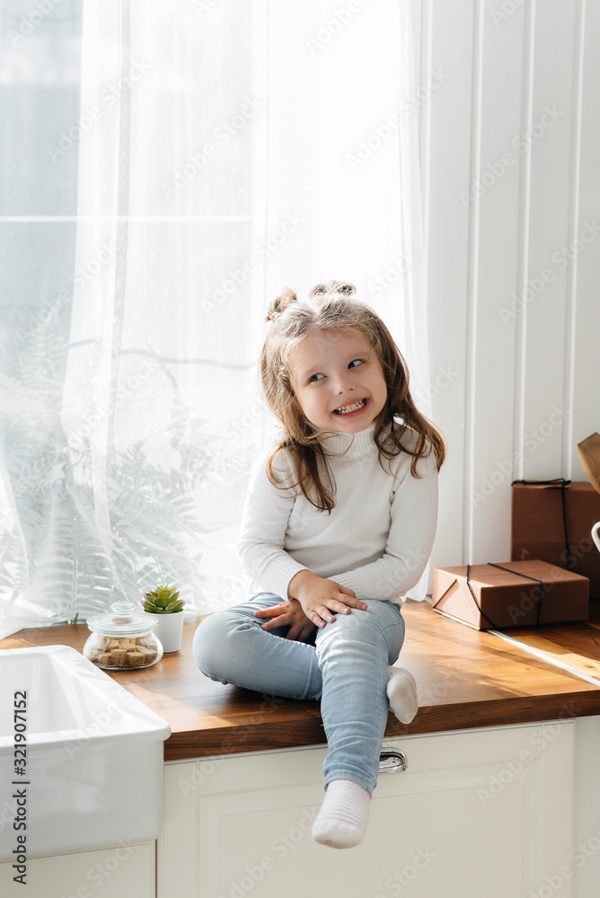 Little cute girl playing in the kitchen, happiness, family. Cooking.