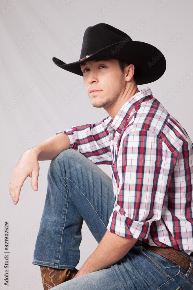 Pensive Cowboy in hat and plaid shrit Pensive Cowboy in hat and plaid shrit