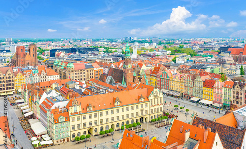Top aerial panoramic view of Wroclaw old town historical city centre with Rynek Market Square, Old Town Hall, New City Hall, colorful buildings with multicolored facade and tiled roofs, Poland