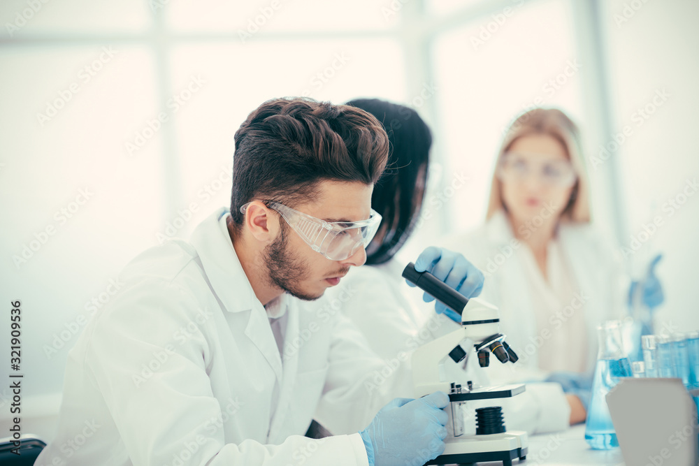 close up. a young scientist studying the features of the coronavirus close up. a young scientist studying the features of the coronavirus