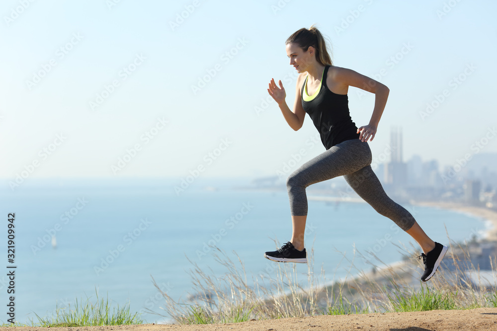 Runner woman running in city outskirts a sunny day Runner woman running in city outskirts a sunny day