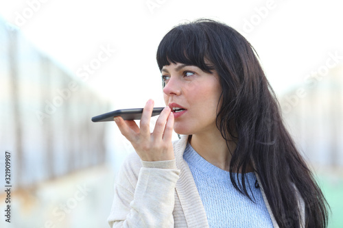 Fotografija Woman recording audio using voice recognition on phone