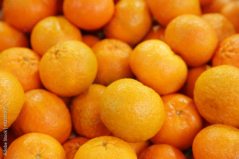 pile of fresh mandarines or tangerines on the market. Tropical citrus concept. pile of fresh mandarines or tangerines on the market. Tropical citrus concept.