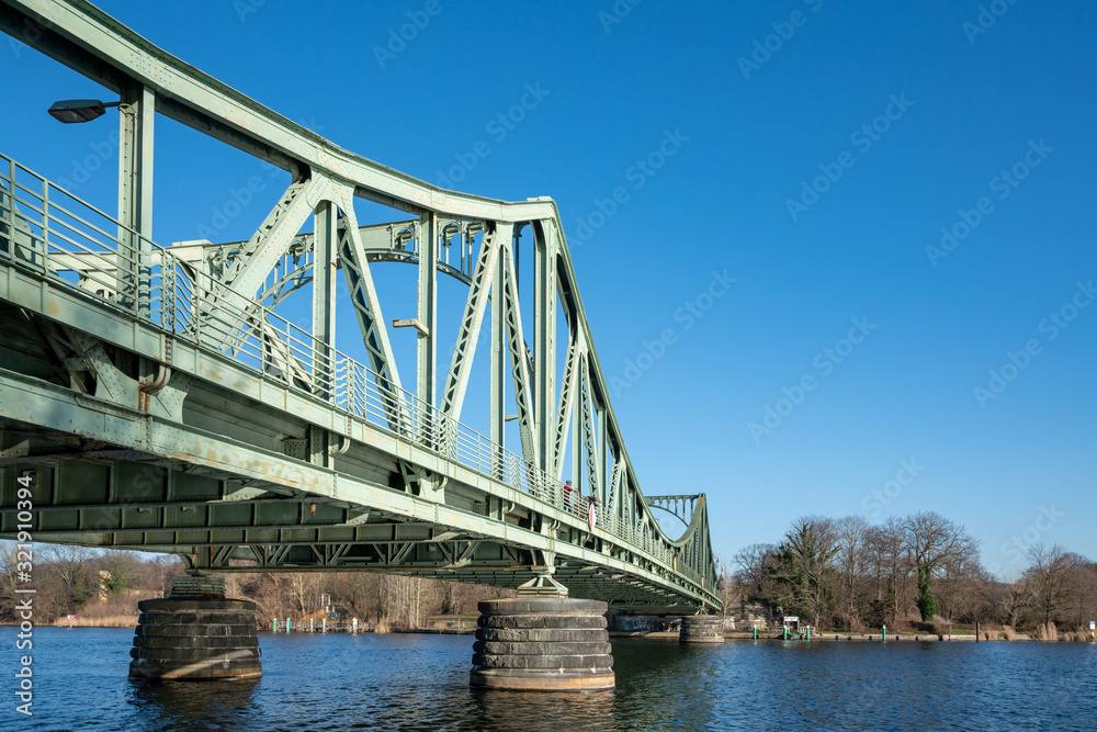 View to the famous Glienicke Bridge, Potsdam, in winter sunny day, named also Bridge of Spies. View to the famous Glienicke Bridge, Potsdam, in winter sunny day, named also Bridge of Spies.