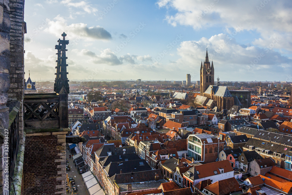 Delft, the Netherlands, Holland,January 18, 2020. Top view from the New Church (Nieuwe Kerk) Bell Tower of a canal and the leaning bell tower of the Oude Kerk (Old church), a Gothic Protestant