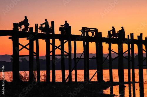 Fényképezés Silhouette of U Bein Bridge at sunrise near Amarapura in Myanmar former Burma
