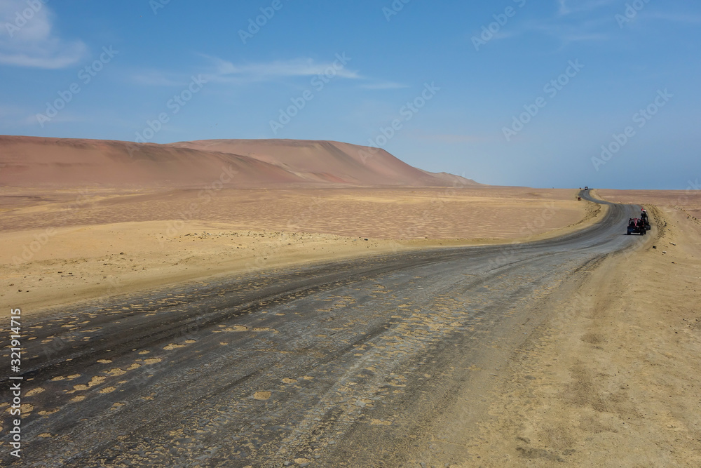 road crossing the Paracas National Reserve. Arid touristic zone in the coast of Ica/Peru.