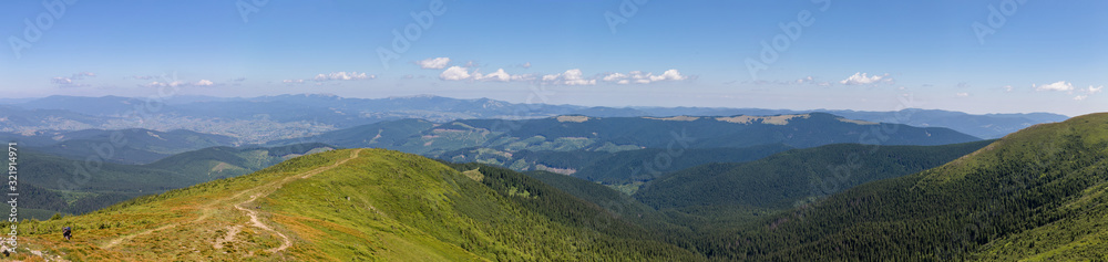 Panorama of green mountains with clouds and forest. Ukraine, Carpathians.