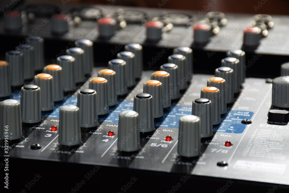 Fototapeta premium Close up of the controls on an audio mixer desk