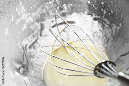 Mixer whisk in a bowl of ingredients