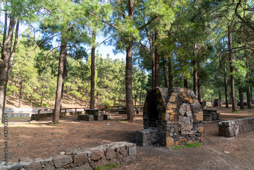 Recreation place in the woods in Gran Canaria with benches and grill spots © condruzmf