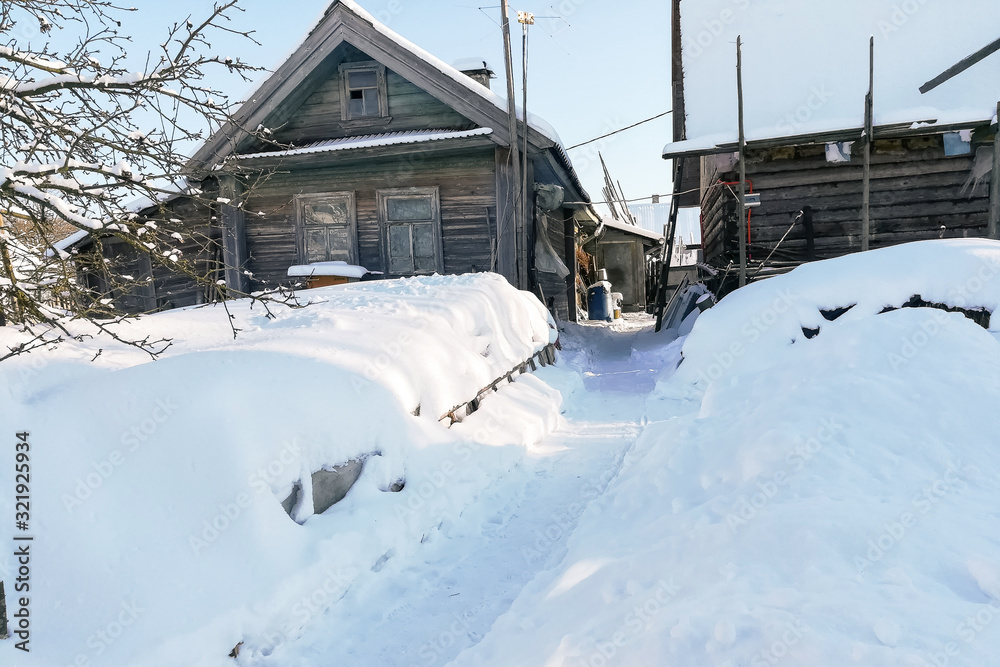 Russian village in winter, in the snow.