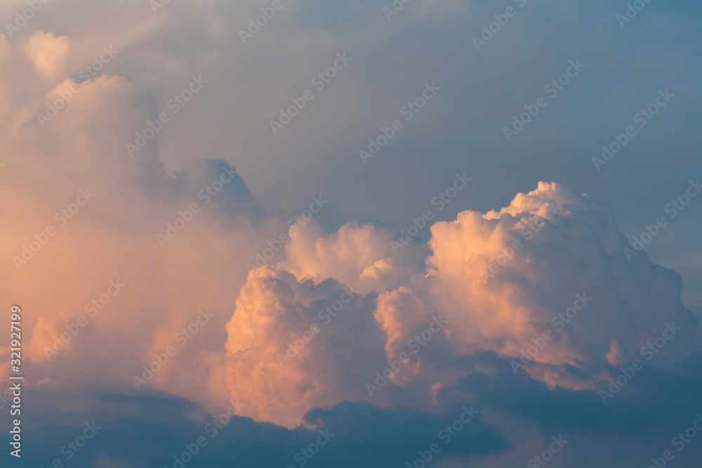 View of beautiful and dramatic blue and orange clouds in the sky at sunset.