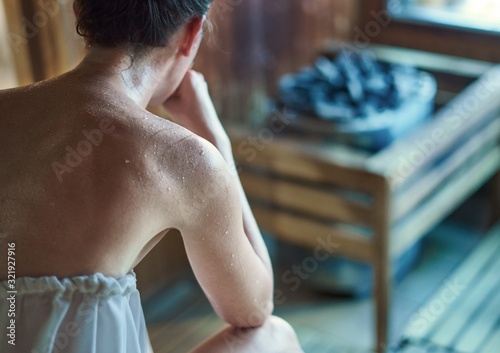 Woman sweating in sauna