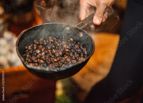 Coffee beans roasting in a cast iron pan
