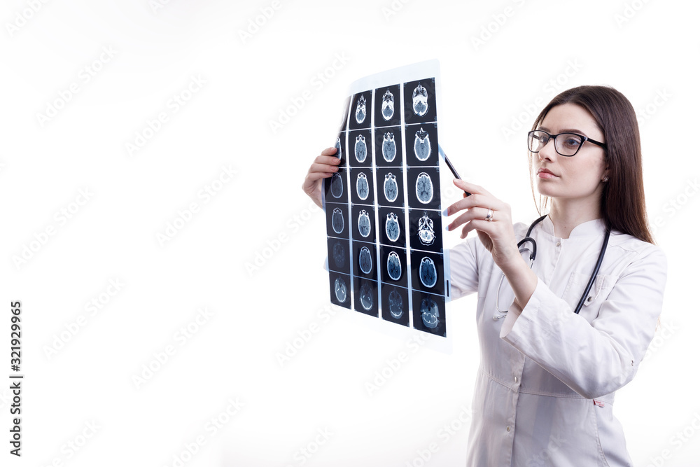 Young medical employee checking brain tomography x-ray film isolated white background copyspace Young medical employee checking brain tomography x-ray film isolated white background copyspace