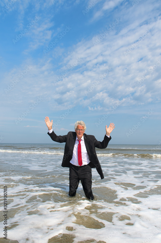 Business man standing at the beach Business man standing at the beach