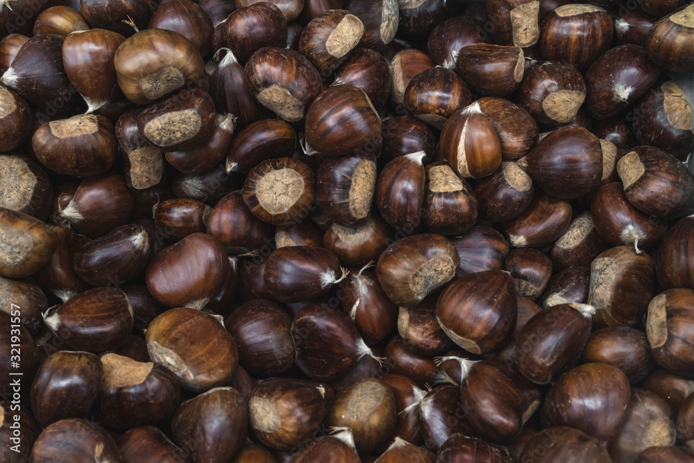 Raw chestnuts close up background. Food Background Raw chestnuts close up background. Food Background